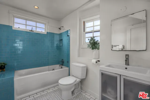 a bathroom with a sink toilet a bathtub and shower