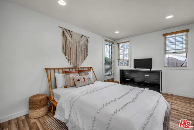 a bedroom with a bed and a flat screen tv