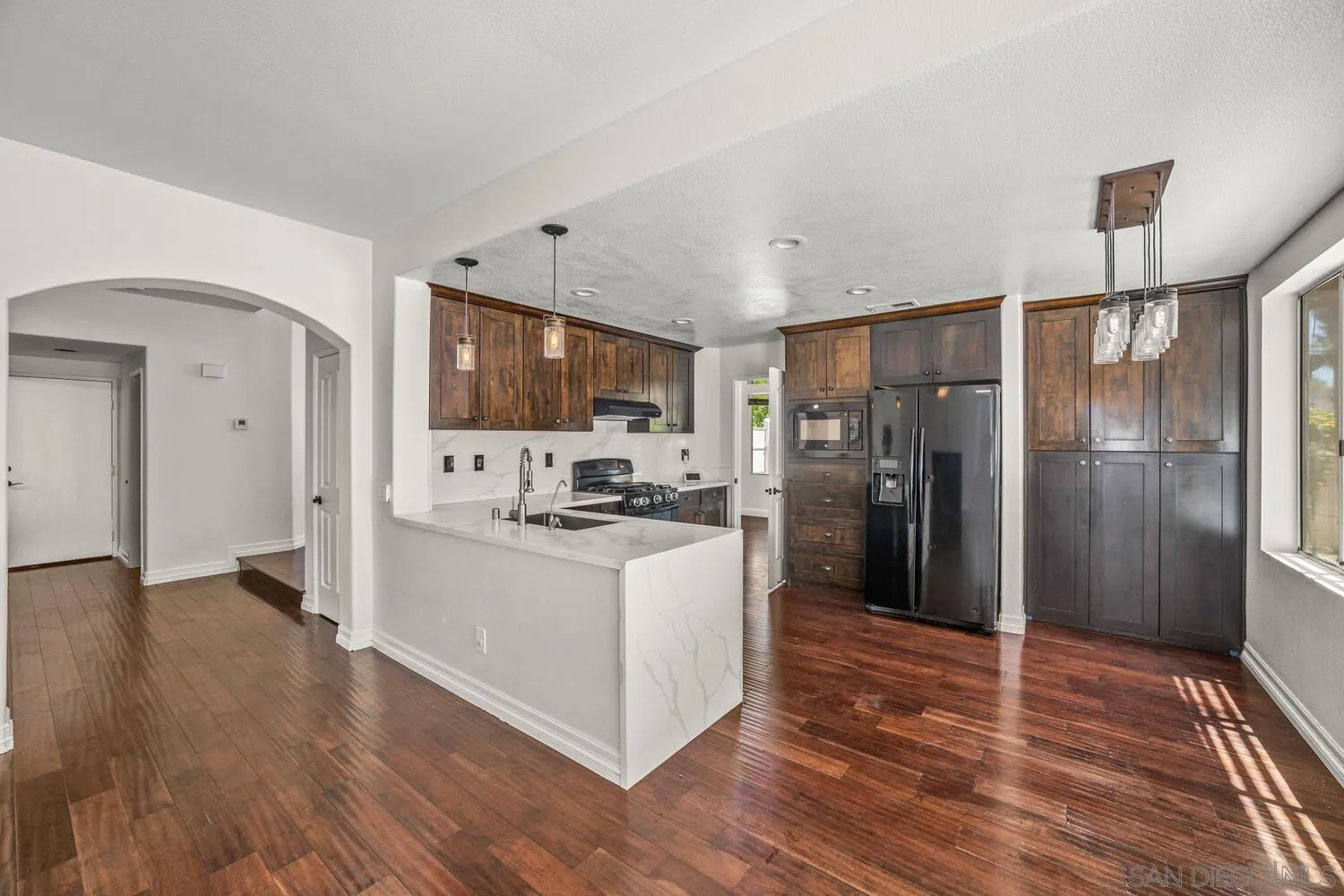1690 Mountain Pass Circle Vista, CA 92081 - Photo 16 of 46 a kitchen with stainless steel appliances a refrigerator and a stove top oven