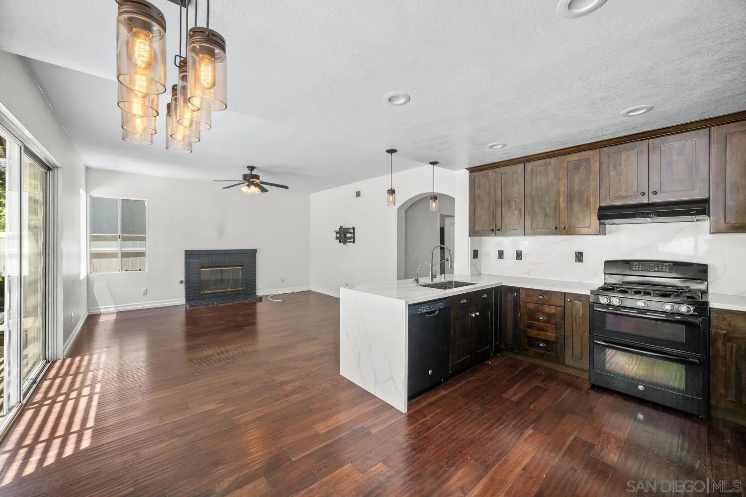 1690 Mountain Pass Circle Vista, CA 92081 - Photo 17 of 46 a kitchen with stainless steel appliances a stove top oven and a refrigerator