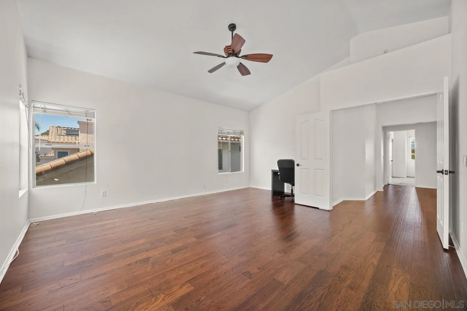 1690 Mountain Pass Circle Vista, CA 92081 - Photo 24 of 46 a view of empty room with wooden floor and ceiling fan