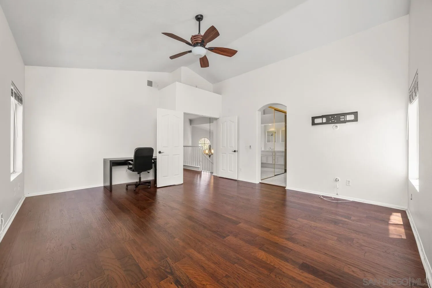 1690 Mountain Pass Circle Vista, CA 92081 - Photo 25 of 46 an empty room with wooden floor and ceiling fan