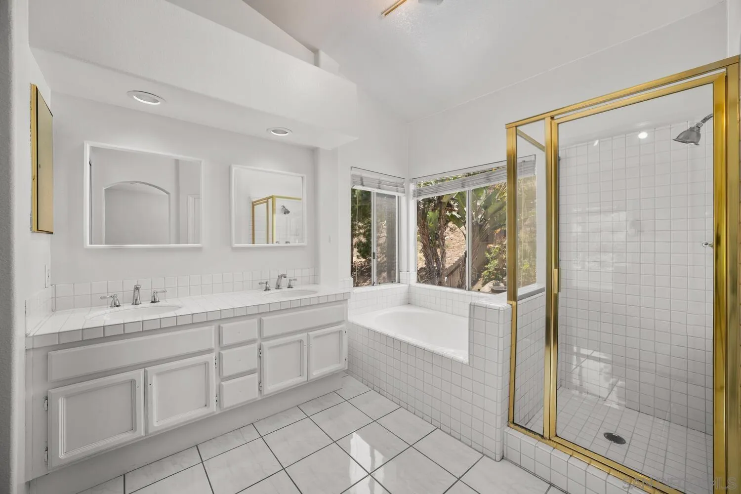 1690 Mountain Pass Circle Vista, CA 92081 - Photo 27 of 46 a bathroom with a tub sink and mirror