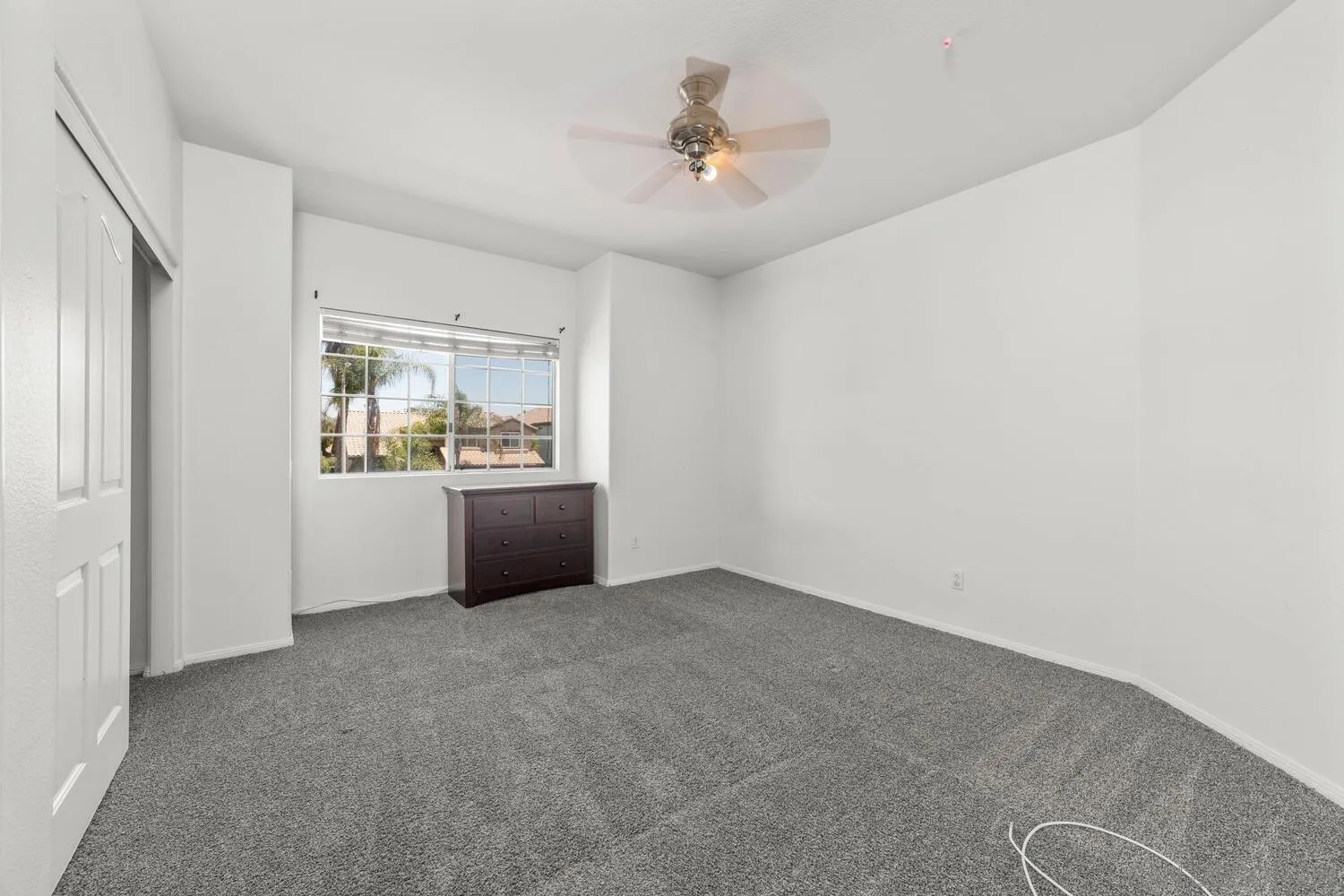 1690 Mountain Pass Circle Vista, CA 92081 - Photo 33 of 46 an empty room with windows and ceiling fan