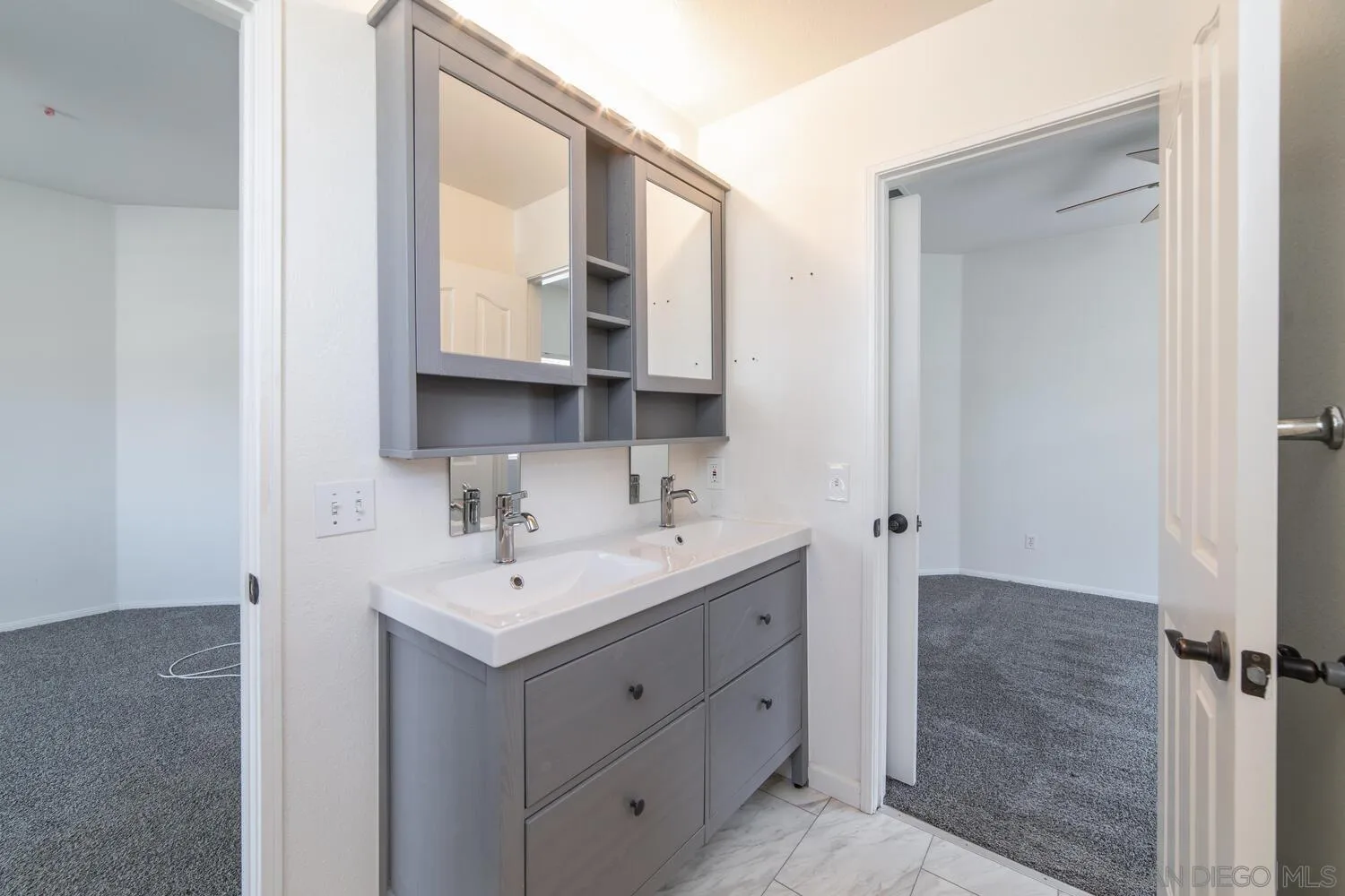 1690 Mountain Pass Circle Vista, CA 92081 - Photo 35 of 46 a bathroom with a sink and a mirror