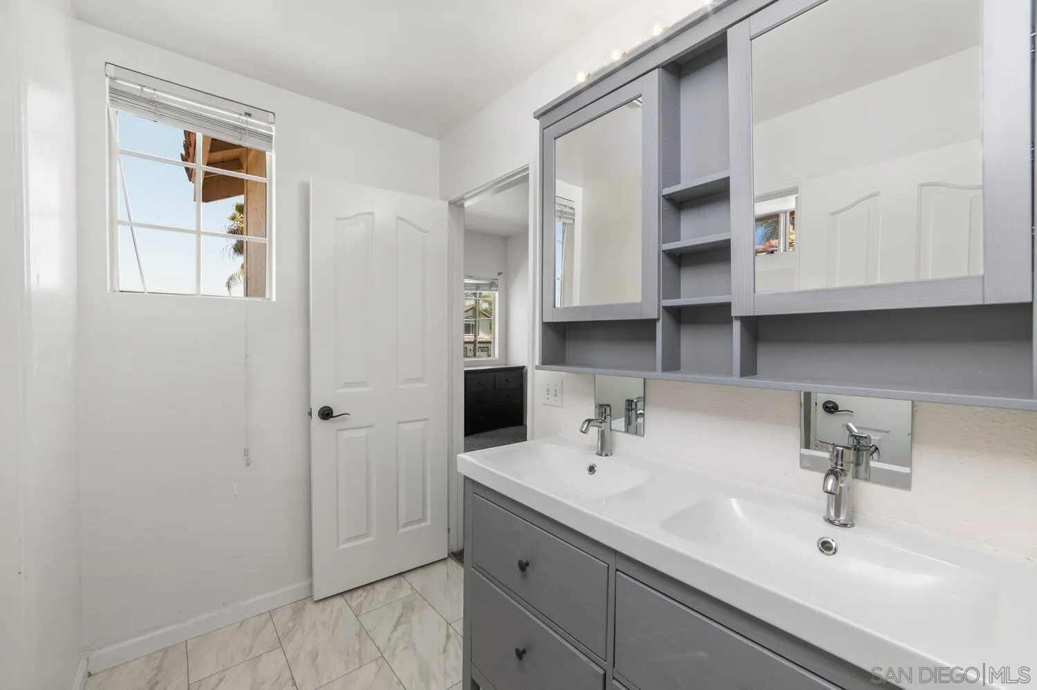 1690 Mountain Pass Circle Vista, CA 92081 - Photo 36 of 46 a bathroom with a sink and a mirror
