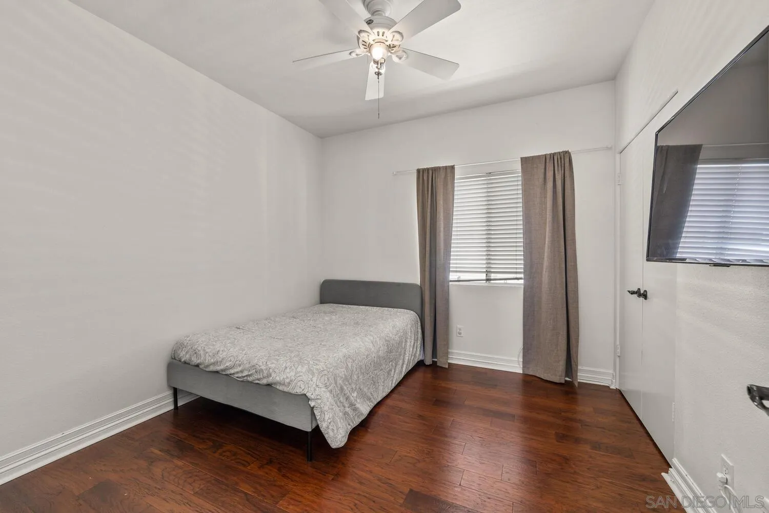 1690 Mountain Pass Circle Vista, CA 92081 - Photo 39 of 46 a bedroom with a bed and wooden floor