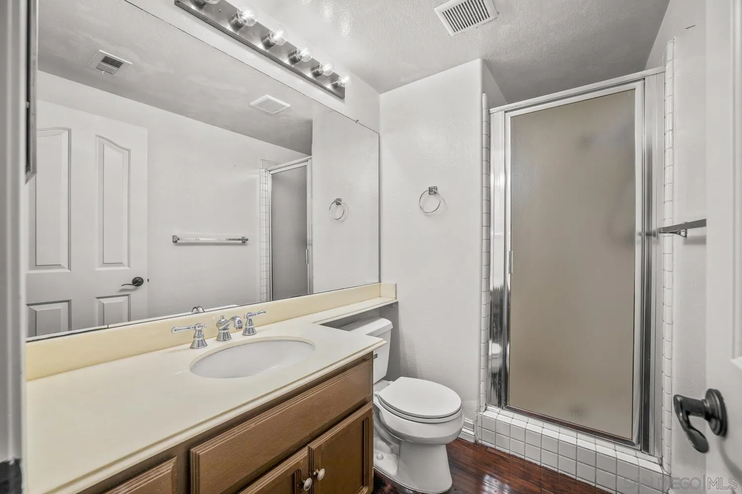 1690 Mountain Pass Circle Vista, CA 92081 - Photo 40 of 46 a bathroom with a sink and a mirror