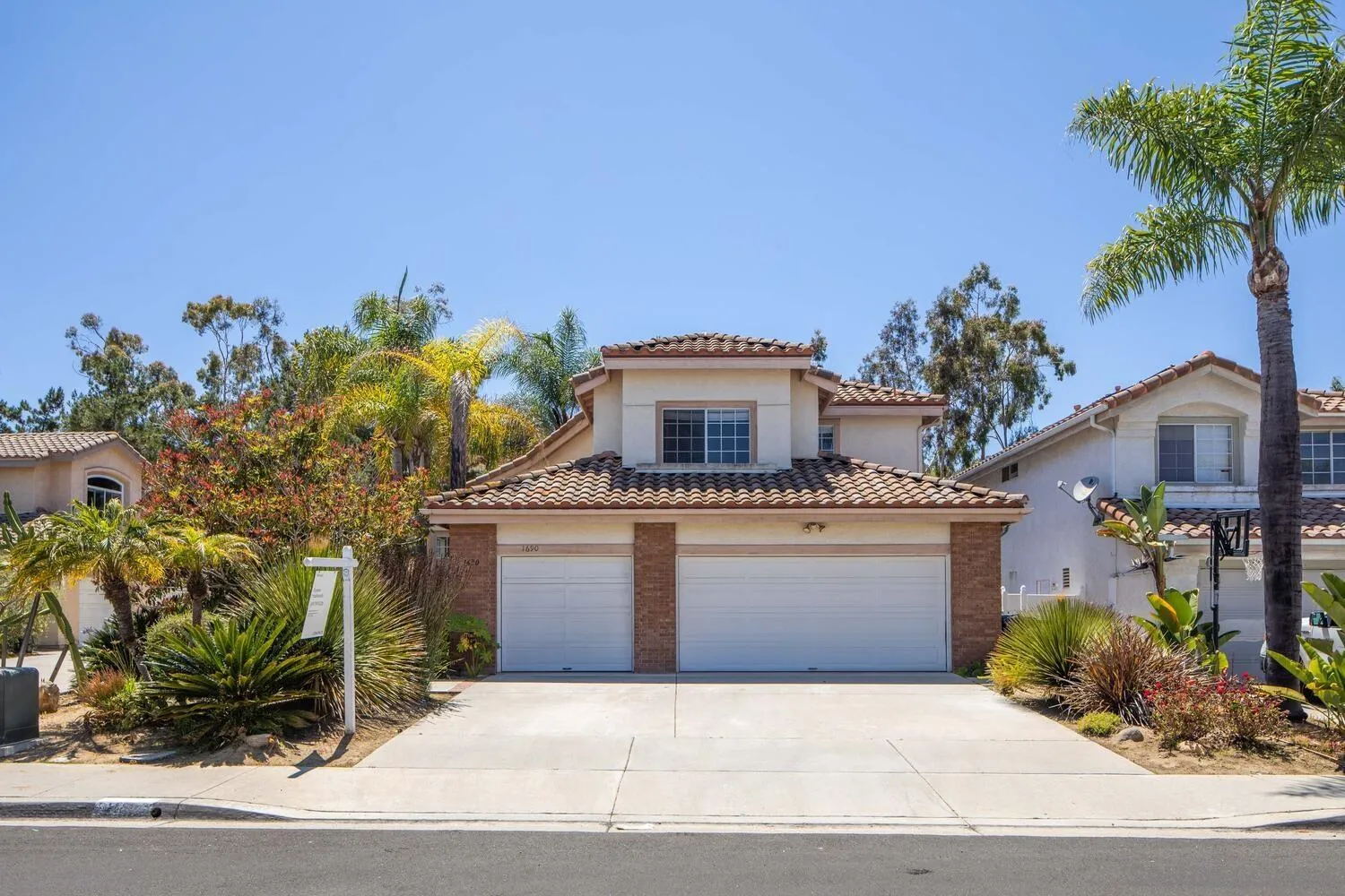 1690 Mountain Pass Circle Vista, CA 92081 - Photo 44 of 46 a front view of a house with a yard and garage