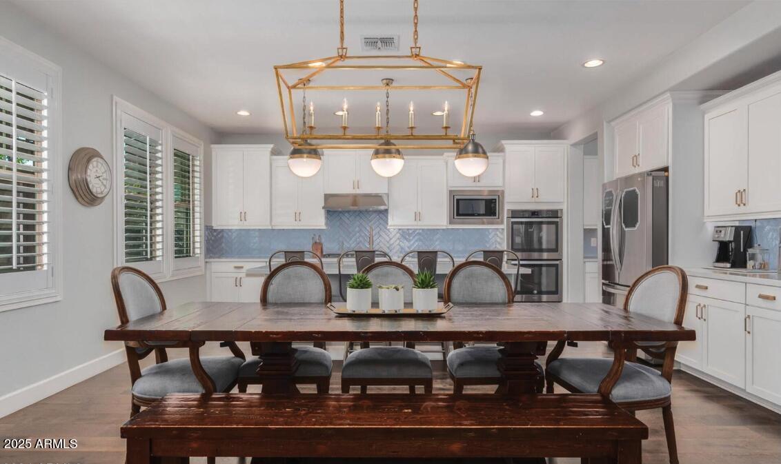 947 West Kaibab Drive Chandler, AZ 85248 - Photo 12 of 32 a kitchen with granite countertop a table chairs stove and cabinets
