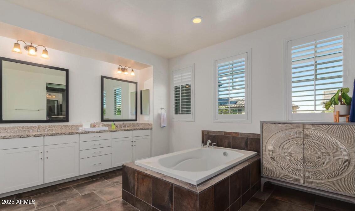 947 West Kaibab Drive Chandler, AZ 85248 - Photo 18 of 32 a spacious bathroom with a double vanity sink a mirror and a bathtub