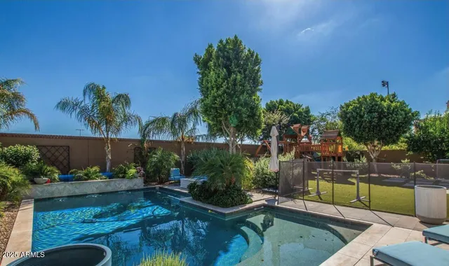 a view of a patio with a table chairs and a backyard