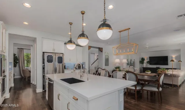 a large kitchen with a table and a large window