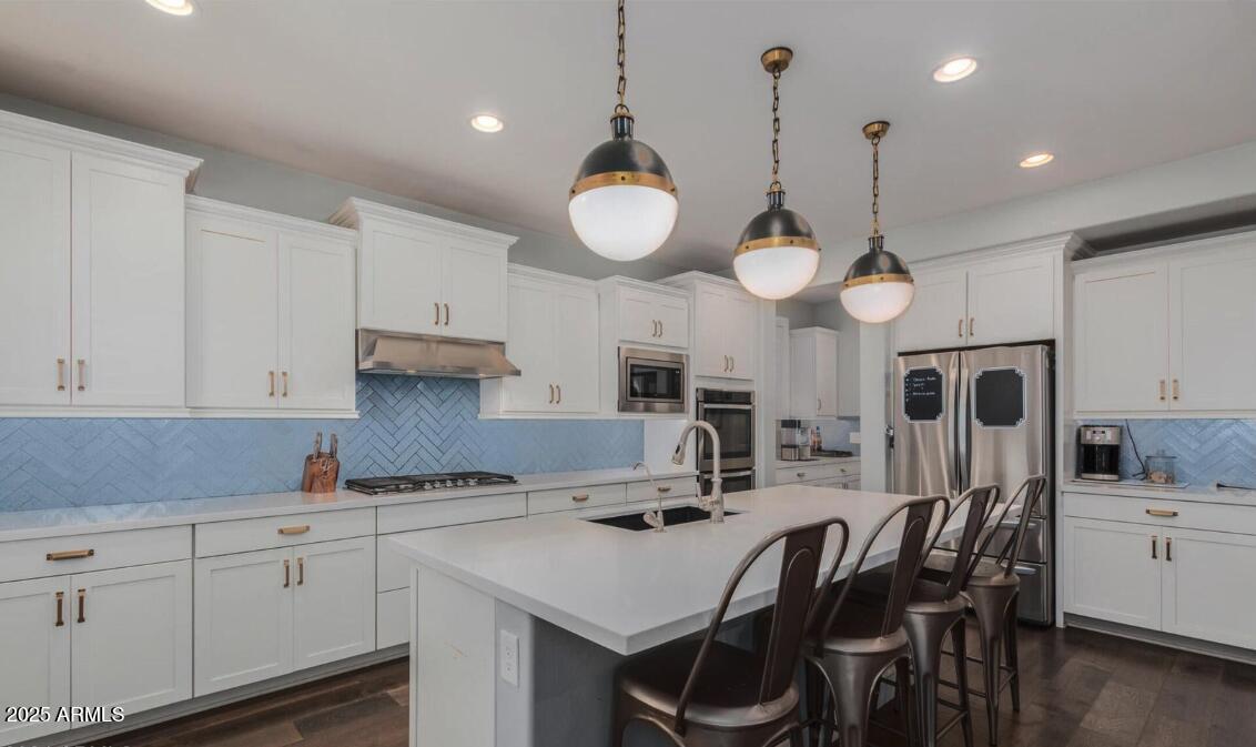 947 West Kaibab Drive Chandler, AZ 85248 - Photo 10 of 32 a kitchen with cabinets a sink appliances and chairs