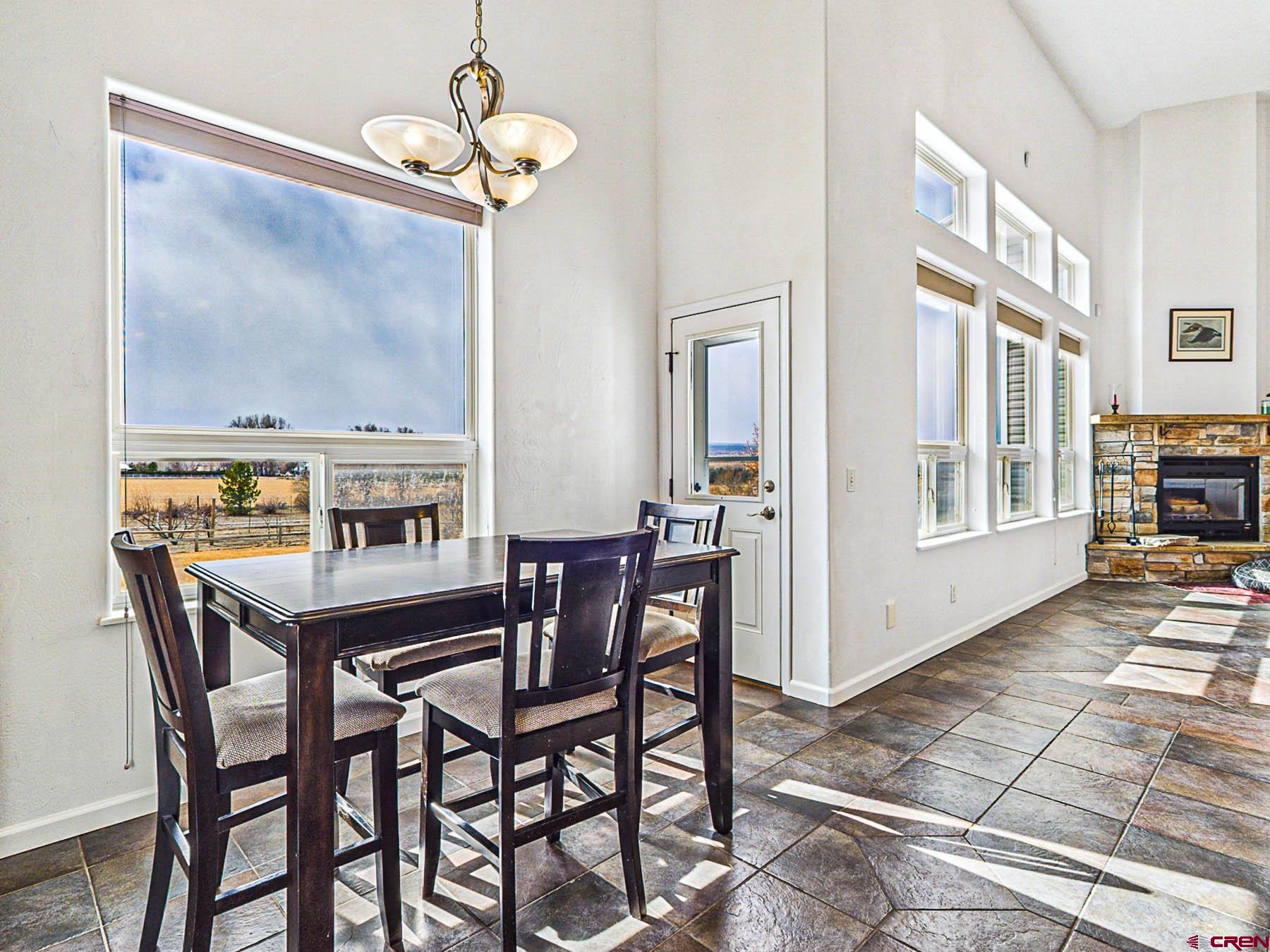 12689 6100th Road Montrose, CO 81403 - Photo 13 of 45 a dining room with a wooden table and chairs