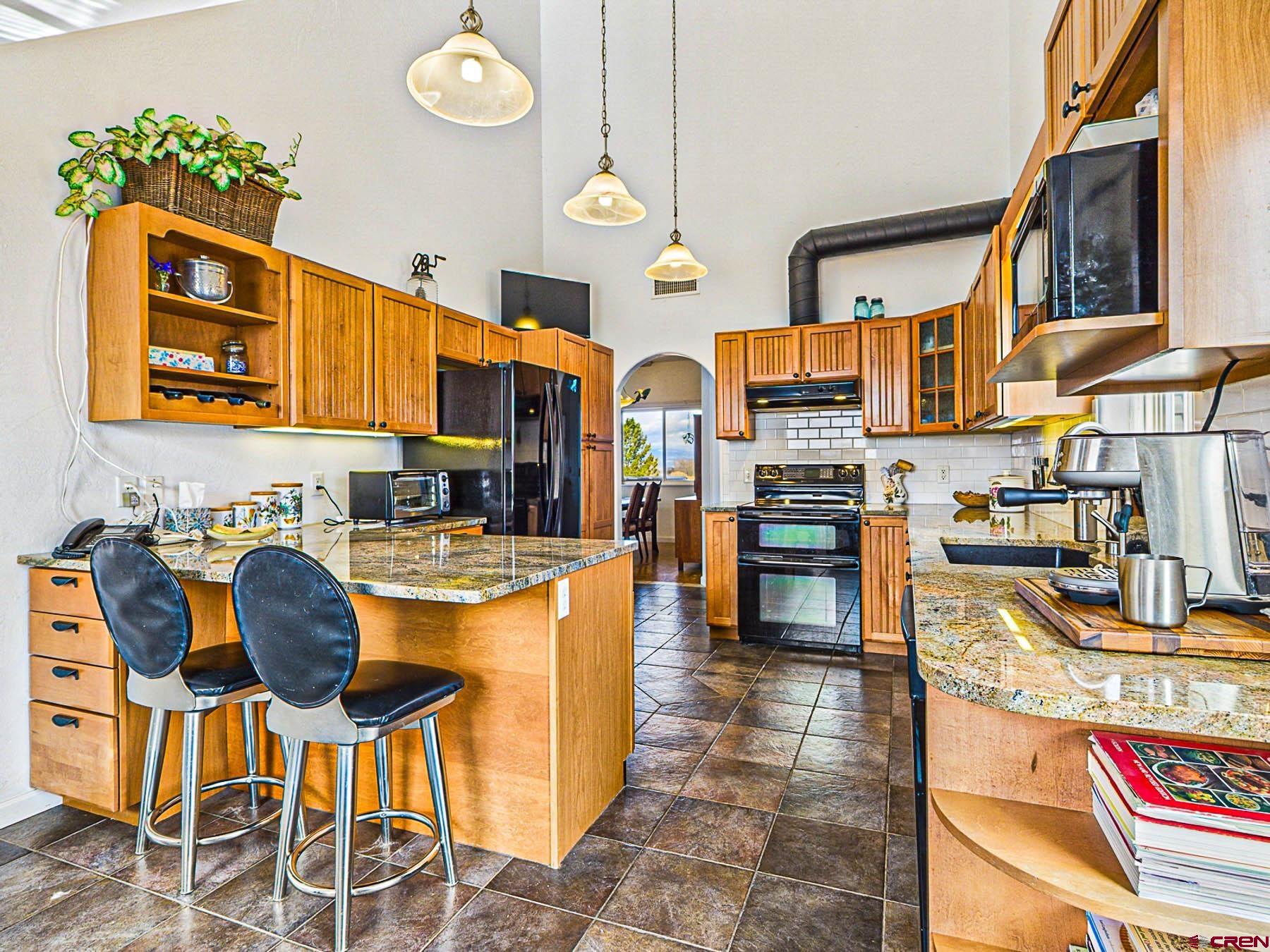12689 6100th Road Montrose, CO 81403 - Photo 14 of 45 a kitchen with stainless steel appliances granite countertop a stove and cabinets
