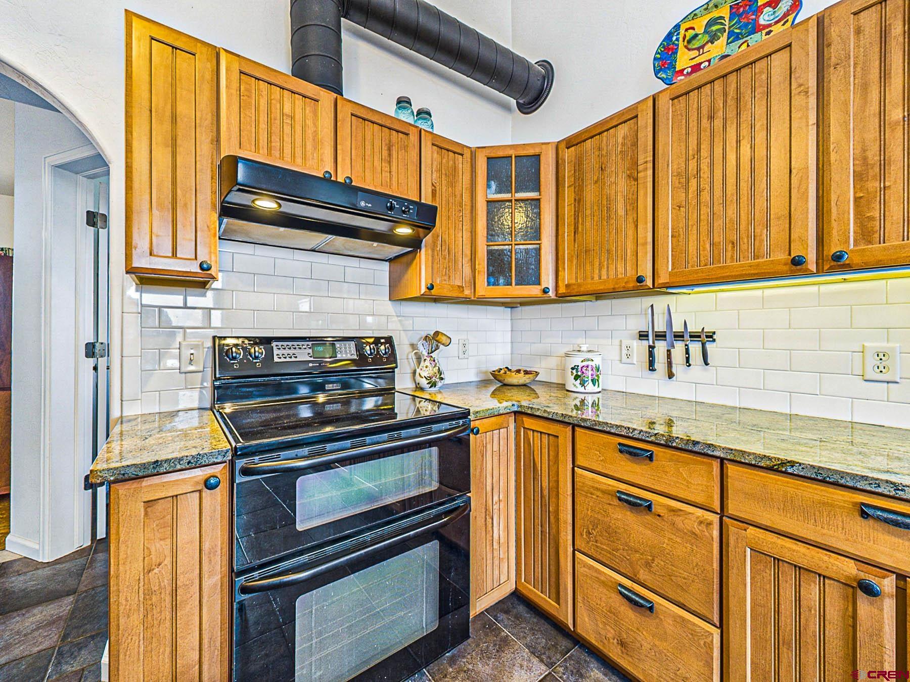 12689 6100th Road Montrose, CO 81403 - Photo 15 of 45 a kitchen with stainless steel appliances granite countertop a stove and a sink