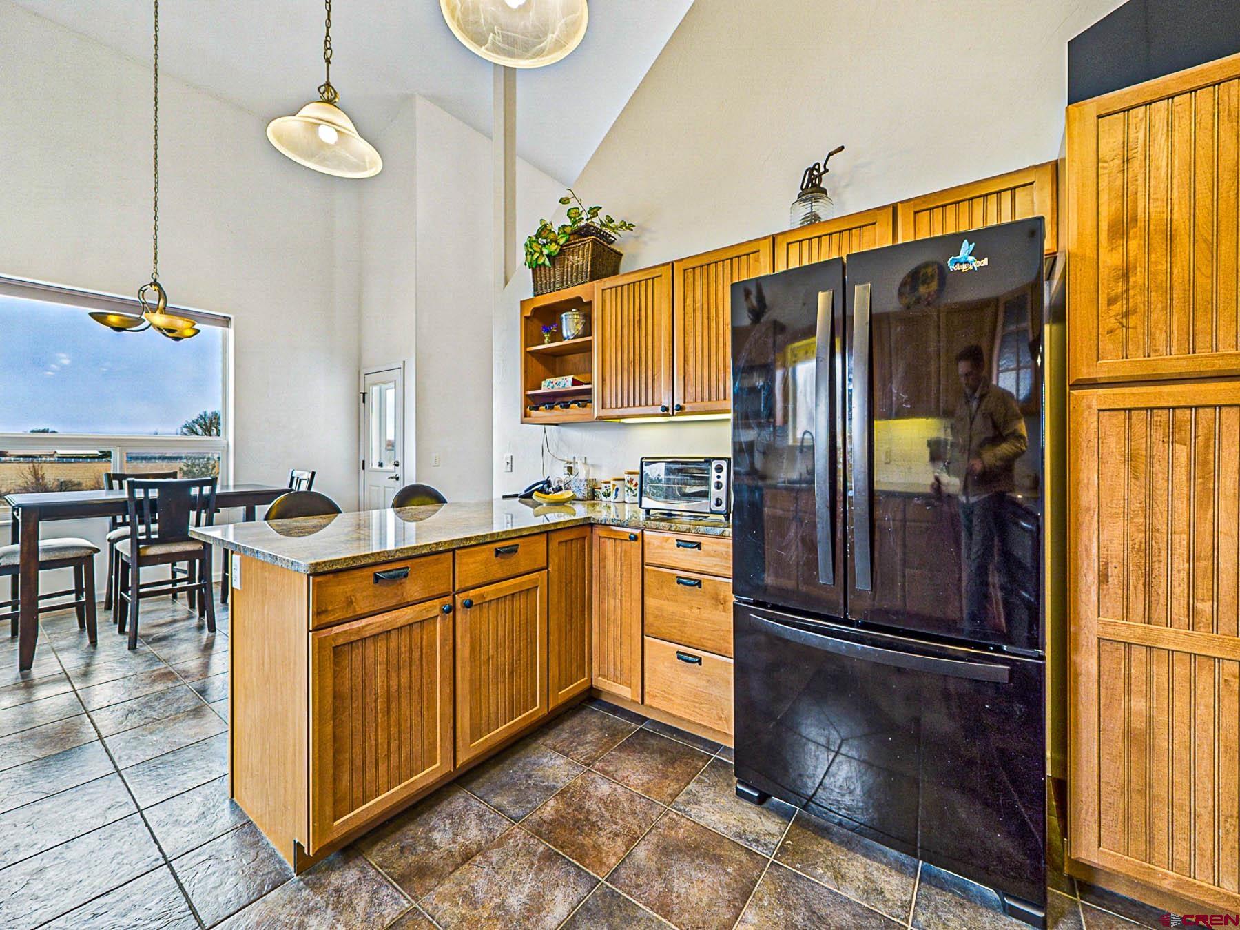 12689 6100th Road Montrose, CO 81403 - Photo 16 of 45 a kitchen with stainless steel appliances granite countertop a refrigerator a oven and a stove