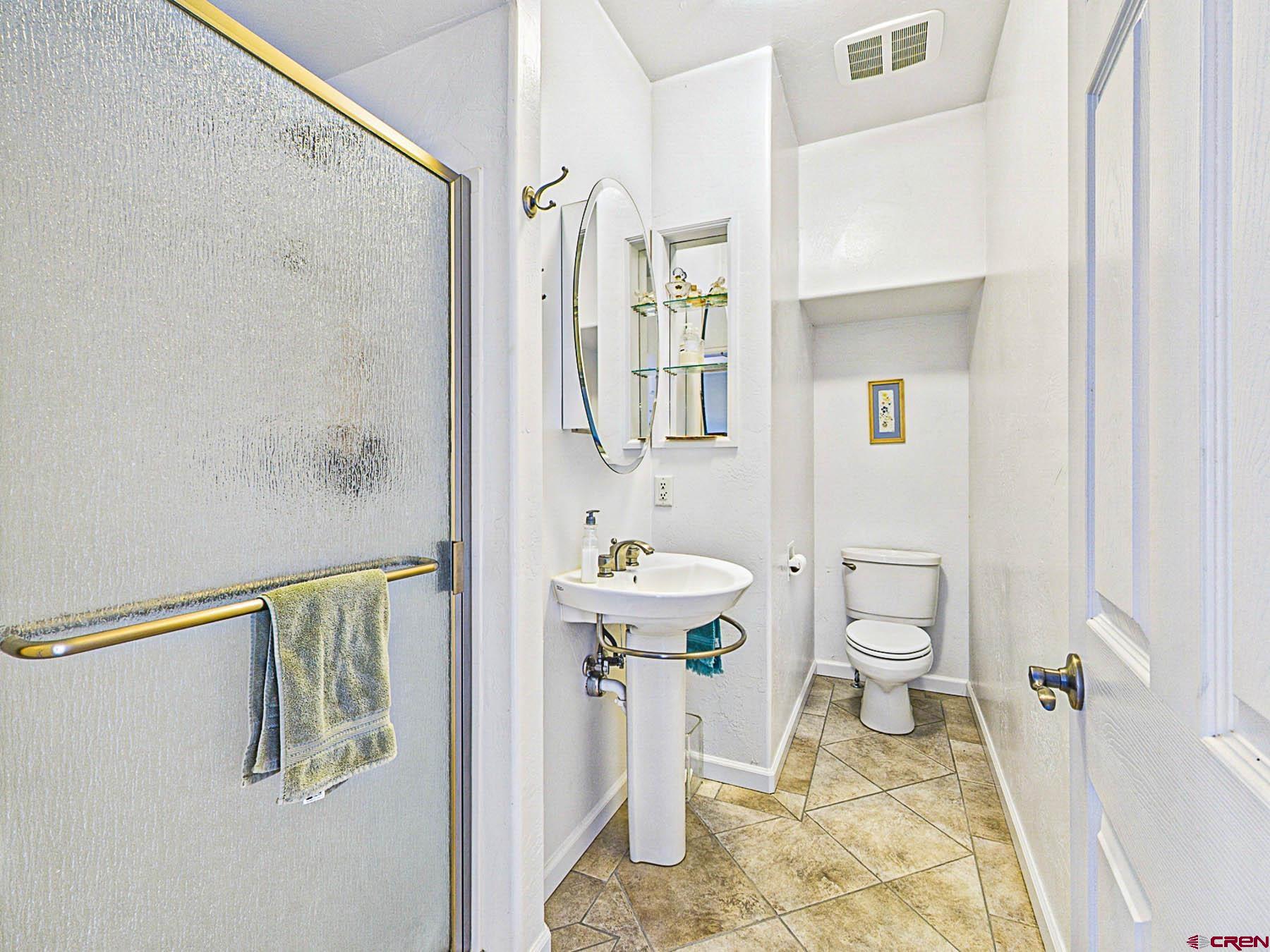 12689 6100th Road Montrose, CO 81403 - Photo 19 of 45 a bathroom with a sink toilet and shower