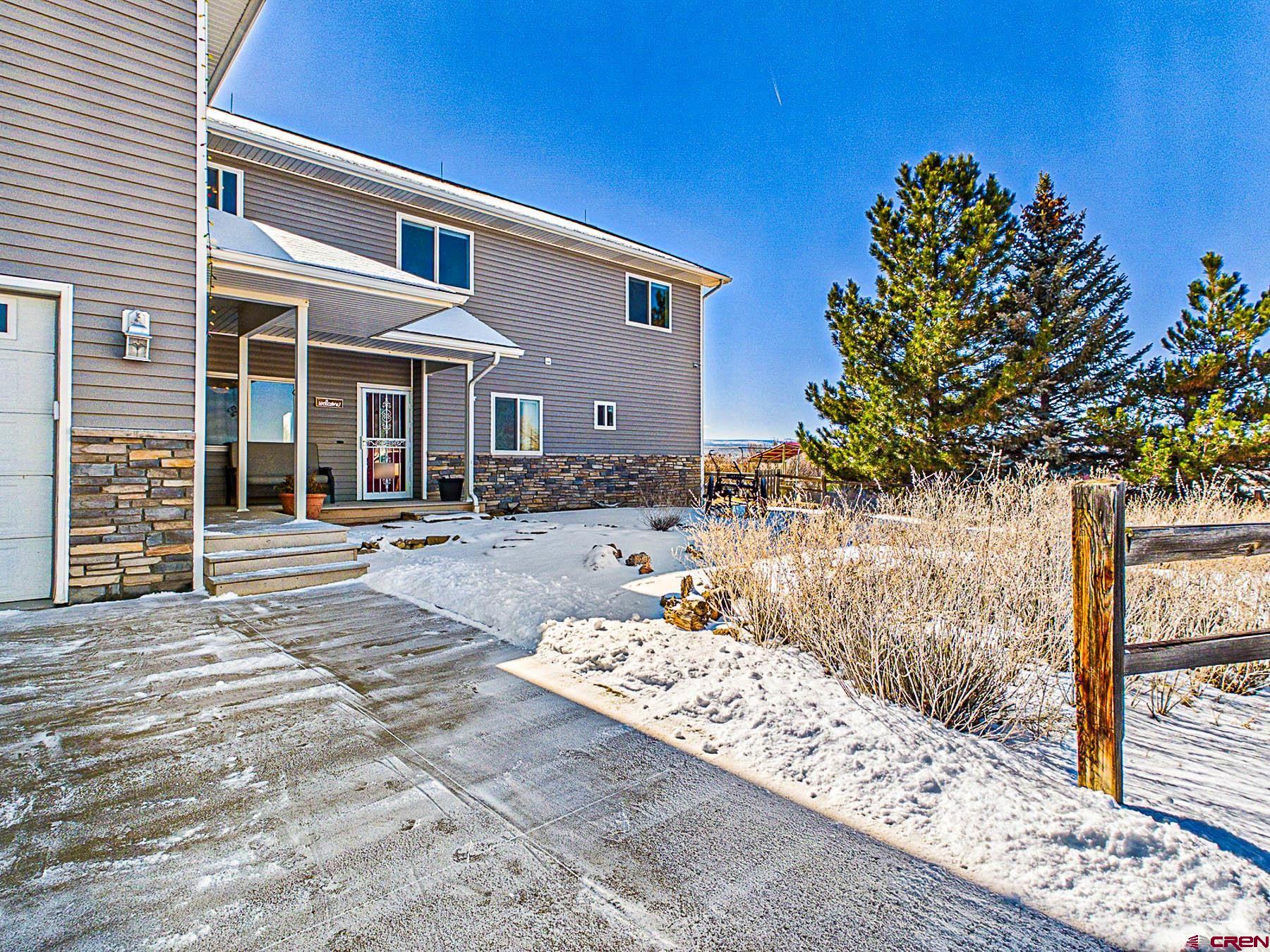 12689 6100th Road Montrose, CO 81403 - Photo 6 of 45 a front view of a house with trees