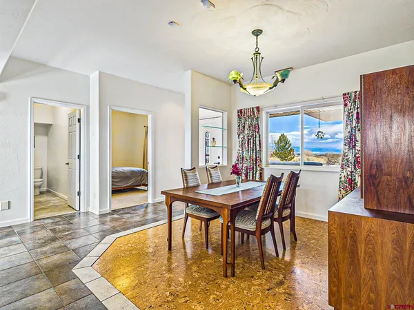 a living room with fireplace furniture and a potted plant