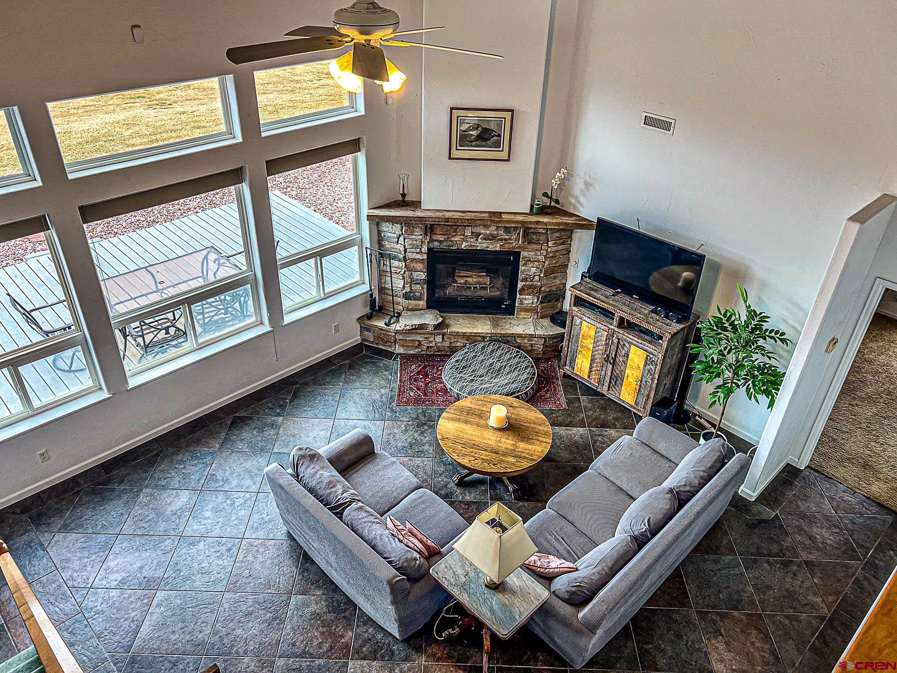 12689 6100th Road Montrose, CO 81403 - Photo 8 of 45 a living room with furniture and a fireplace