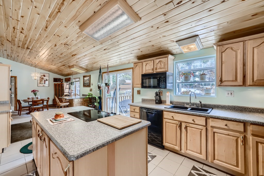 808 Deer Path Road Dillon, CO 80435 - Photo 4 of 39 a kitchen with a stove a sink dishwasher and a microwave oven with cabinets