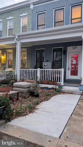 a view of a house with a bench in wooden floor