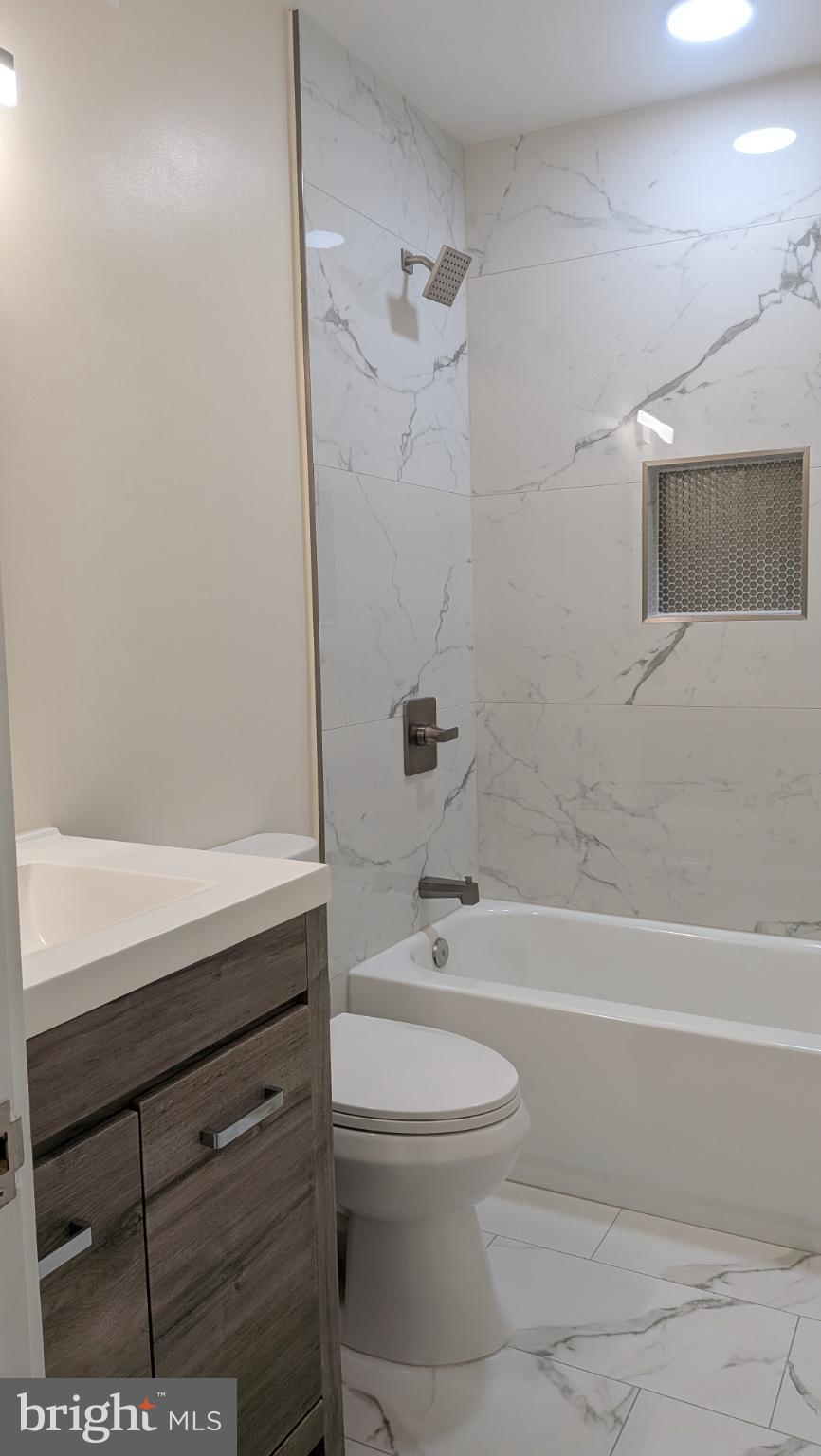 329 16th Street Southeast, Unit 1 Washington, DC 20003 - Photo 21 of 22 a bathroom with a toilet a sink and bathtub