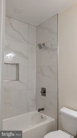 a bathroom with a bathtub and a toilet
