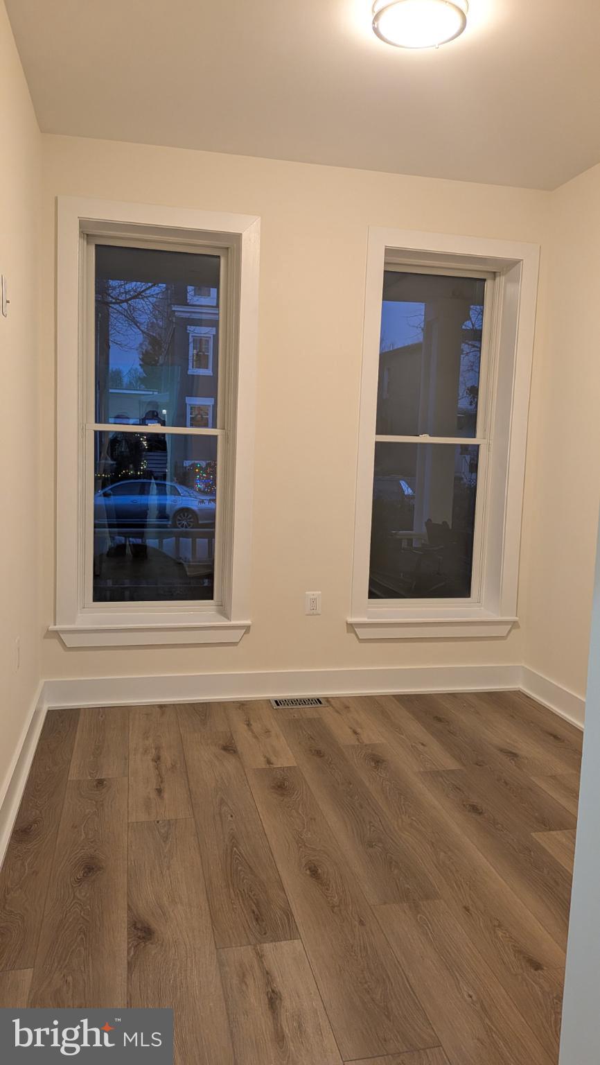 329 16th Street Southeast, Unit 1 Washington, DC 20003 - Photo 9 of 22 a view of an empty room with wooden floor and a window