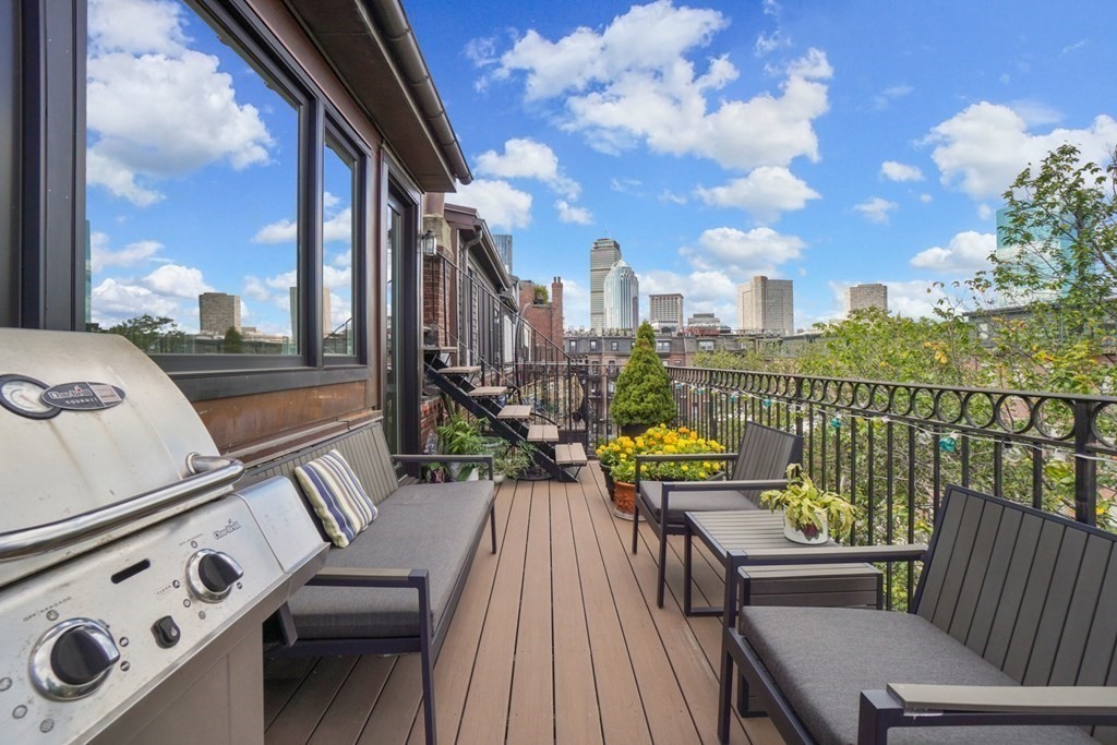 59 Rutland Street, Unit 3 Boston, MA 02118 - Photo 23 of 40 a view of a balcony with chairs and wooden floor