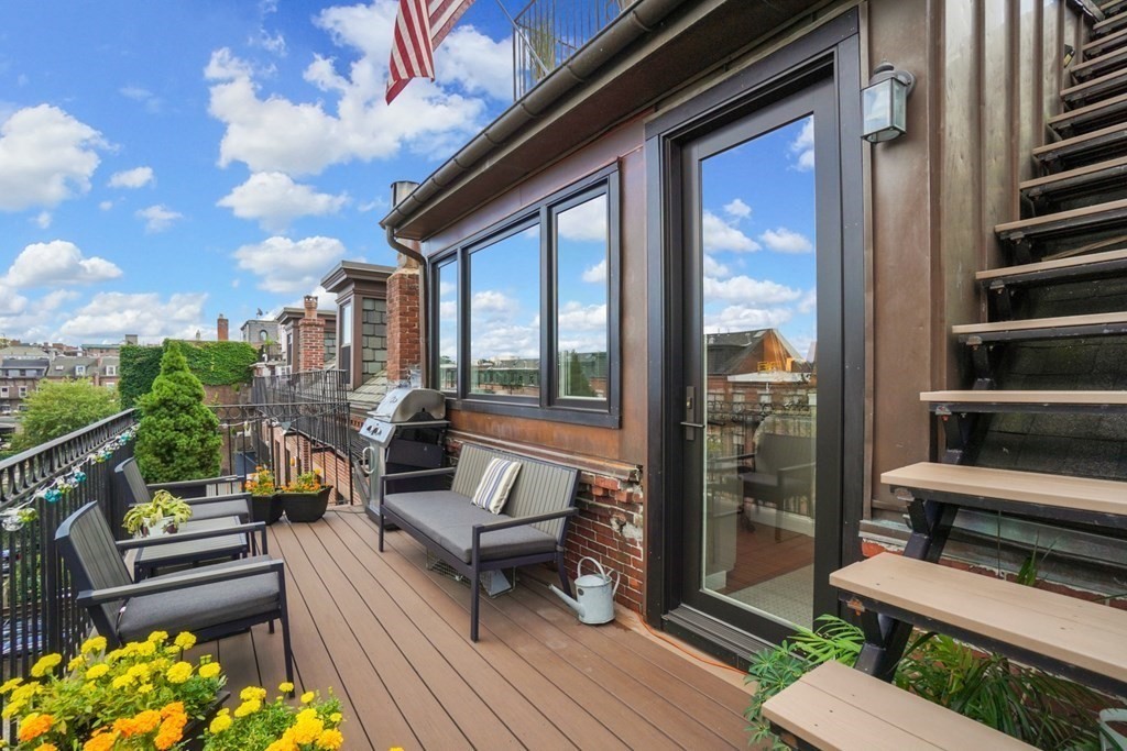 59 Rutland Street, Unit 3 Boston, MA 02118 - Photo 24 of 40 a balcony with wooden floor and outdoor seating