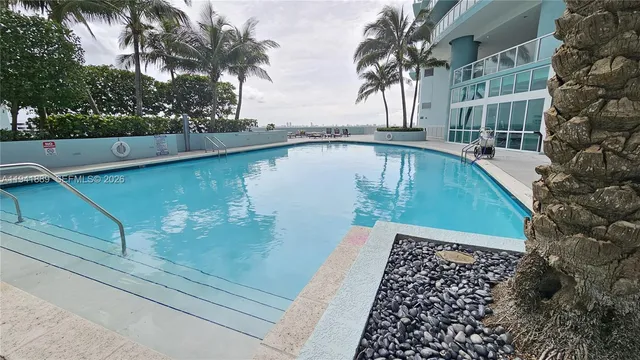 a view of a hallway with wooden floor and closet