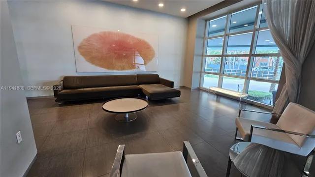 a lobby with furniture and a large window