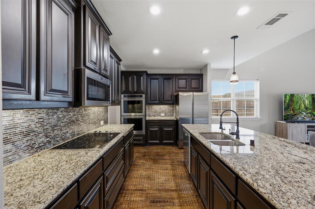 1215 The Trails Drive Blue Ridge, TX 75424 - Photo 9 of 40 Gourmet Kitchen with Granite Counters, Decorative Backsplash and Stainless Appliances.
