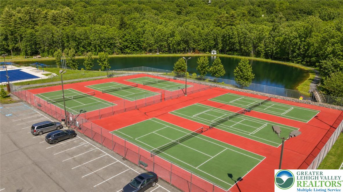1007 Hampstead Road Bushkill, PA 18324 - Photo 58 of 72 Six well-maintained tennis courts are set beside a peaceful pond with lush woodlands beyond.