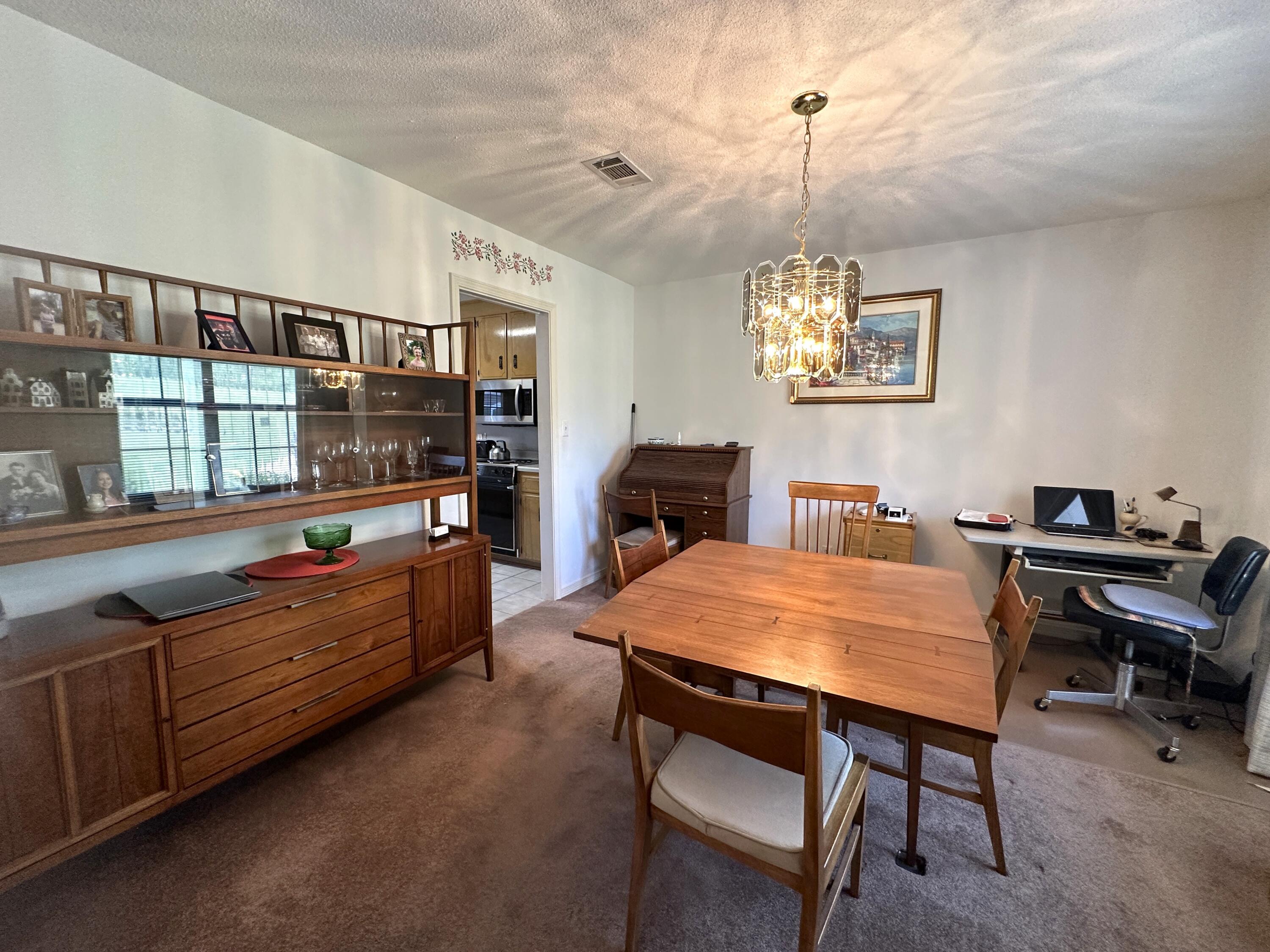 3864 Bear Head Road Crestview, FL 32539 - Photo 11 of 57 a dining room with a wooden table and chairs
