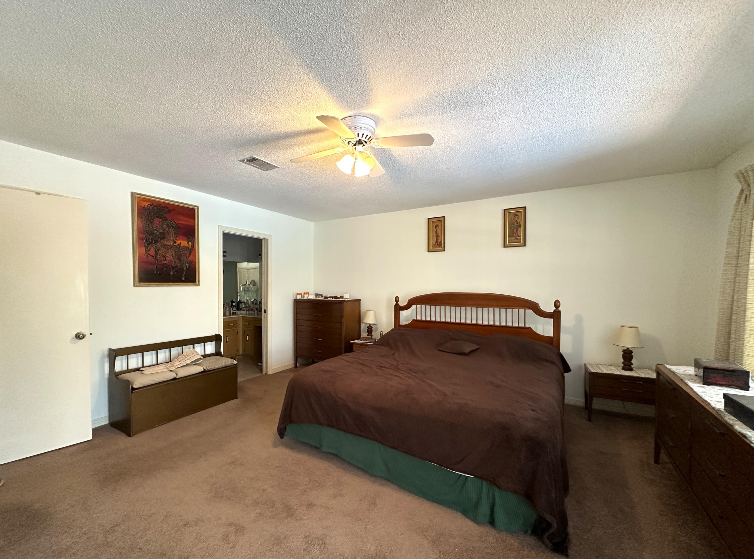 3864 Bear Head Road Crestview, FL 32539 - Photo 13 of 57 a bedroom with a bed and a chandelier