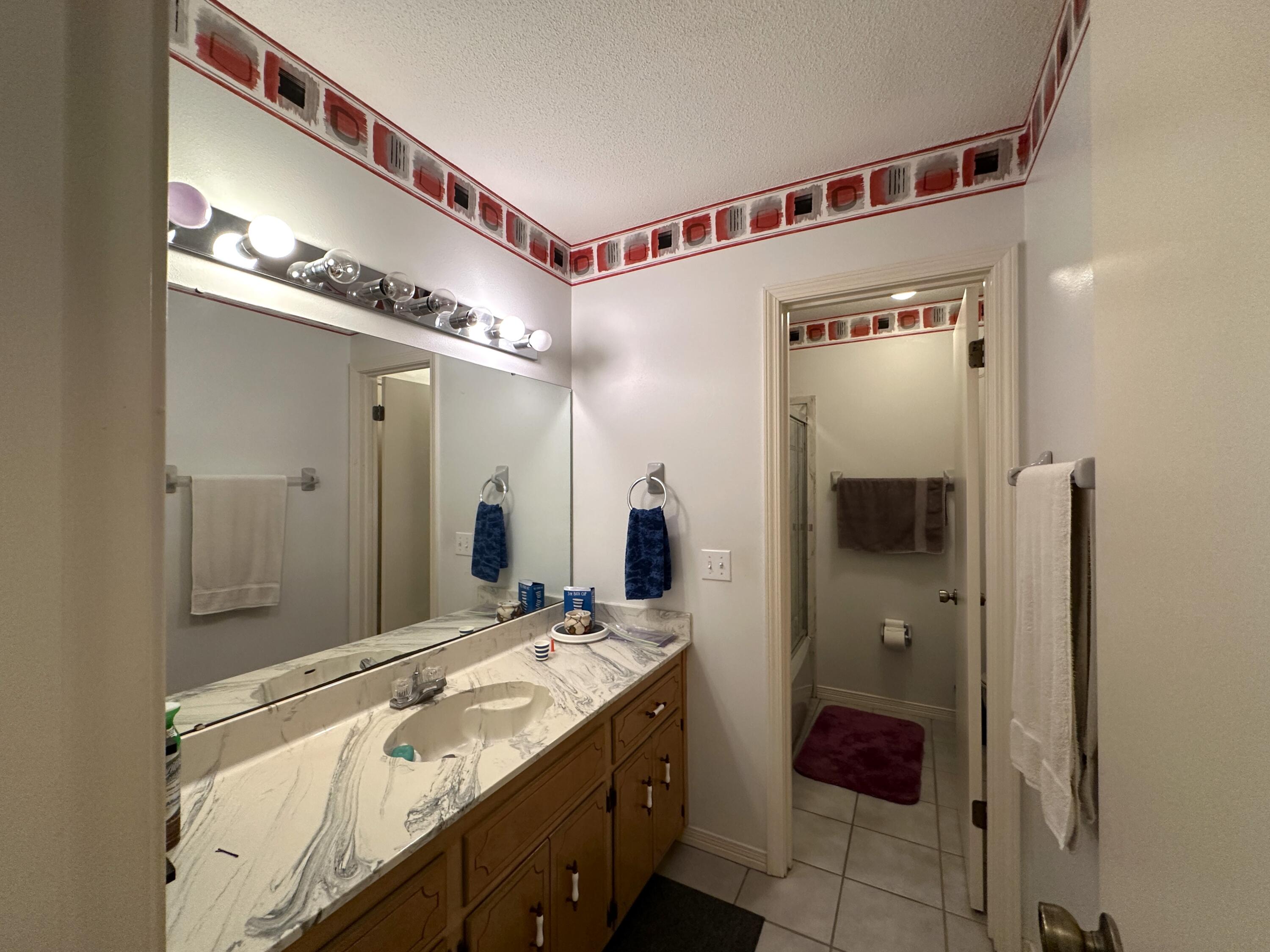3864 Bear Head Road Crestview, FL 32539 - Photo 15 of 57 a bathroom with a granite countertop sink a mirror and shower