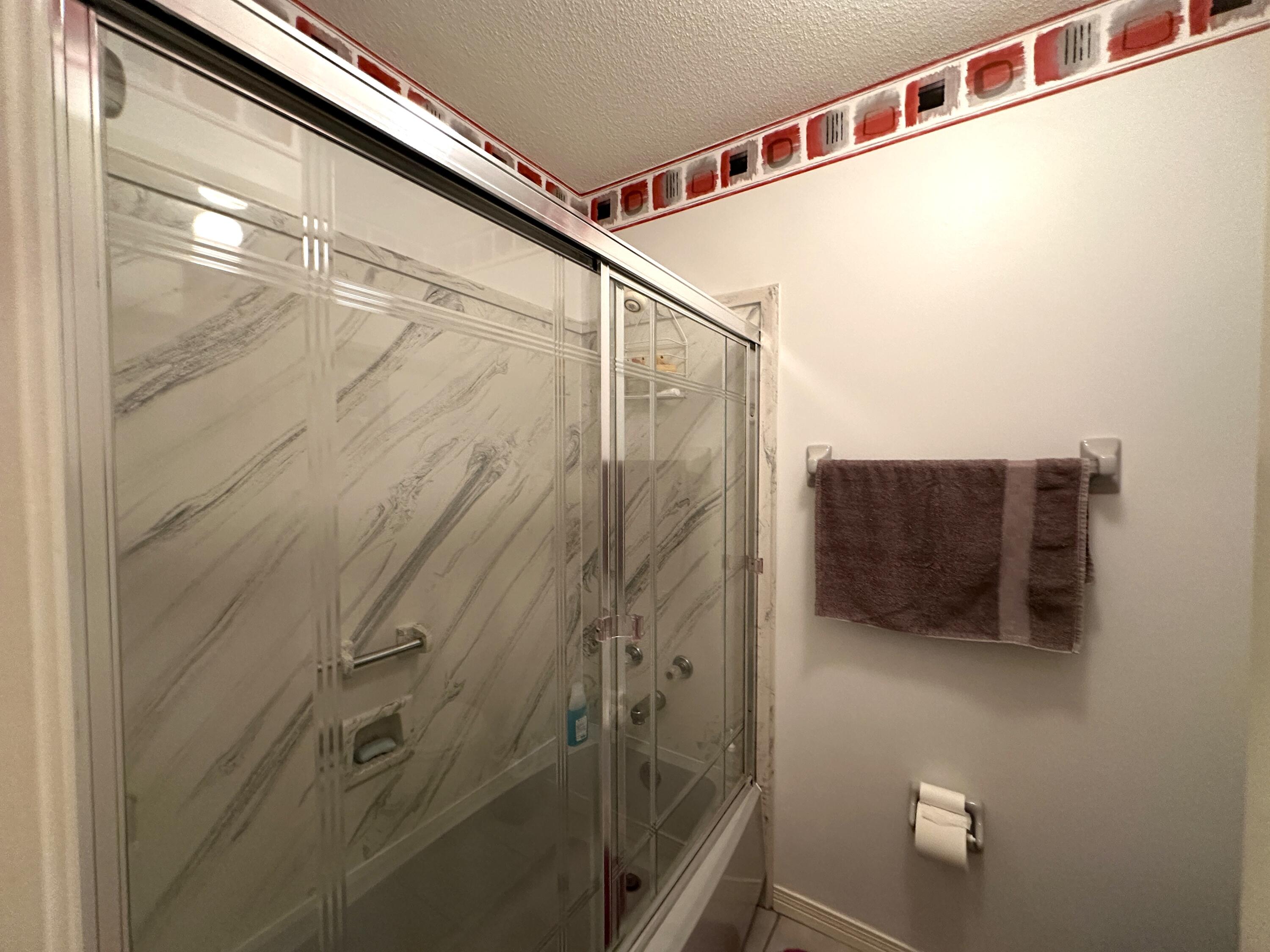 3864 Bear Head Road Crestview, FL 32539 - Photo 16 of 57 a bathroom with a shower and a mirror