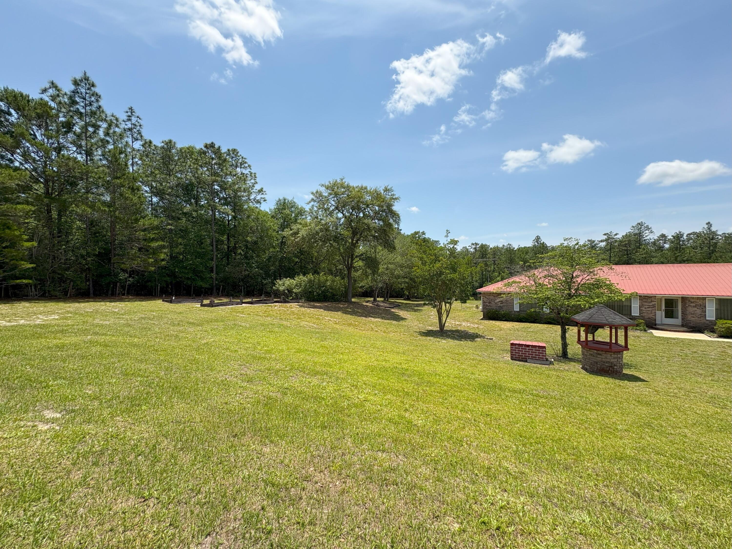 3864 Bear Head Road Crestview, FL 32539 - Photo 20 of 57 a swimming pool with an outdoor space and seating area