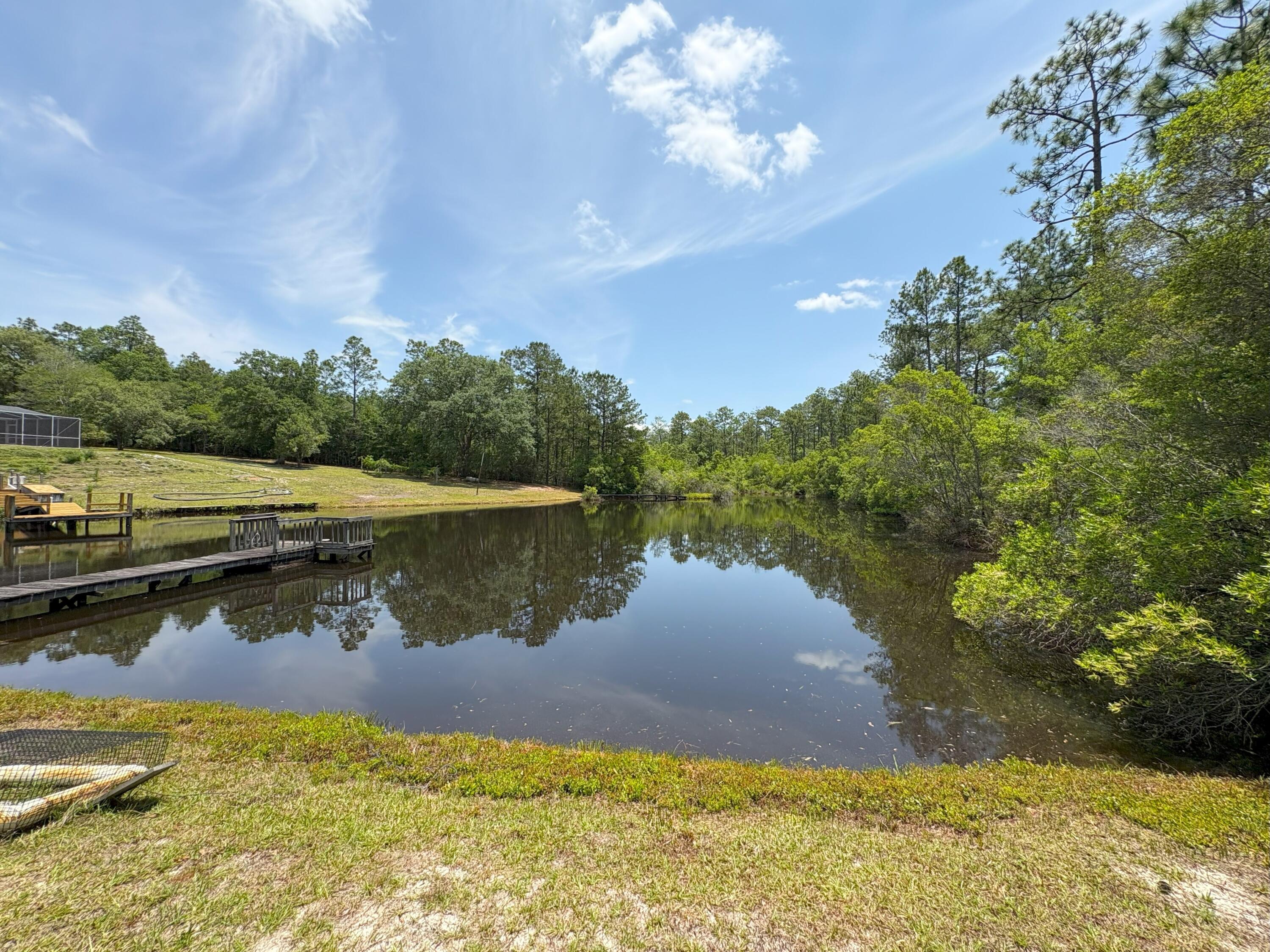 3864 Bear Head Road Crestview, FL 32539 - Photo 27 of 57 a view of a lake with a yard