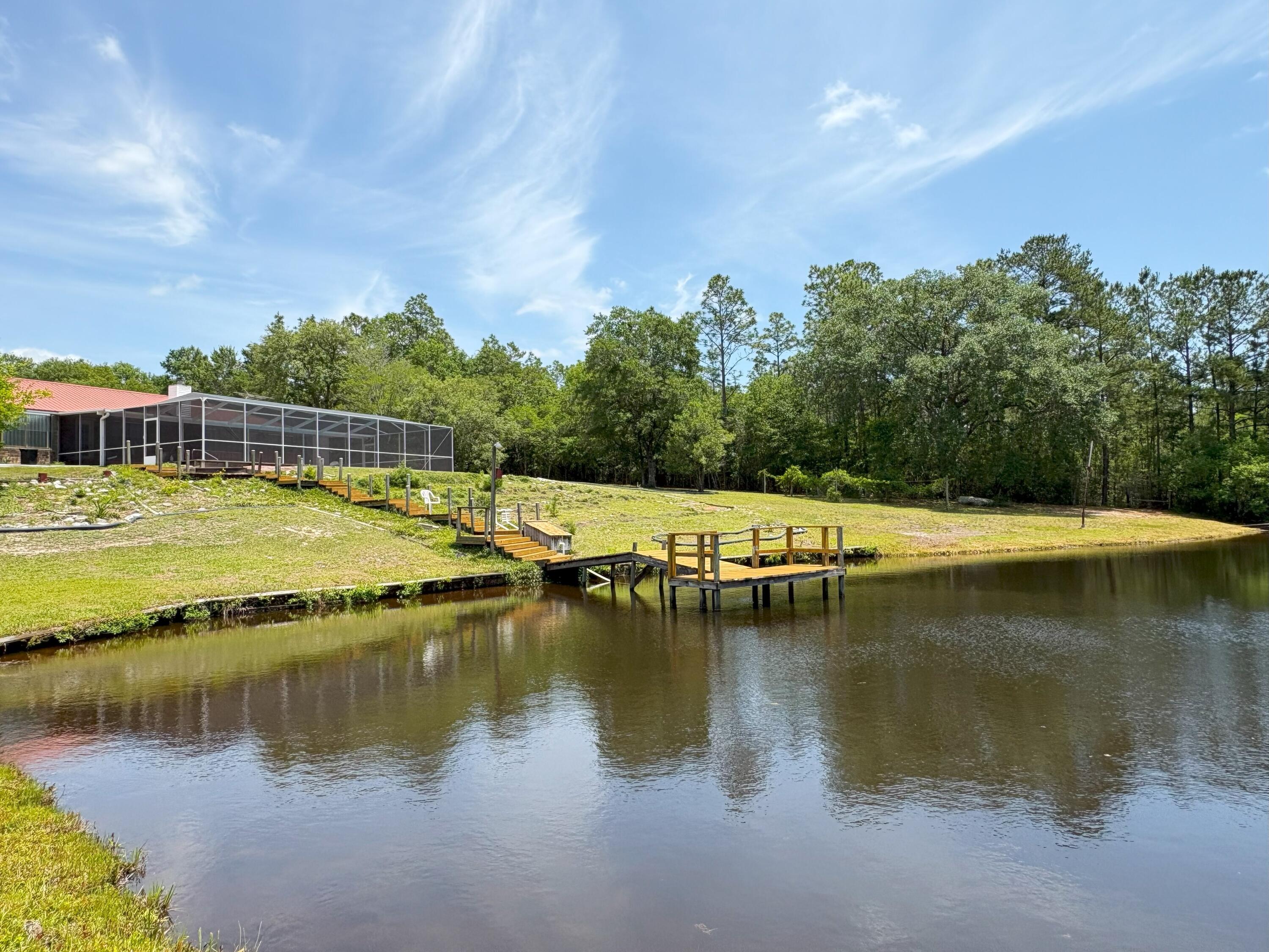 3864 Bear Head Road Crestview, FL 32539 - Photo 3 of 57 a view of a lake with houses in the back