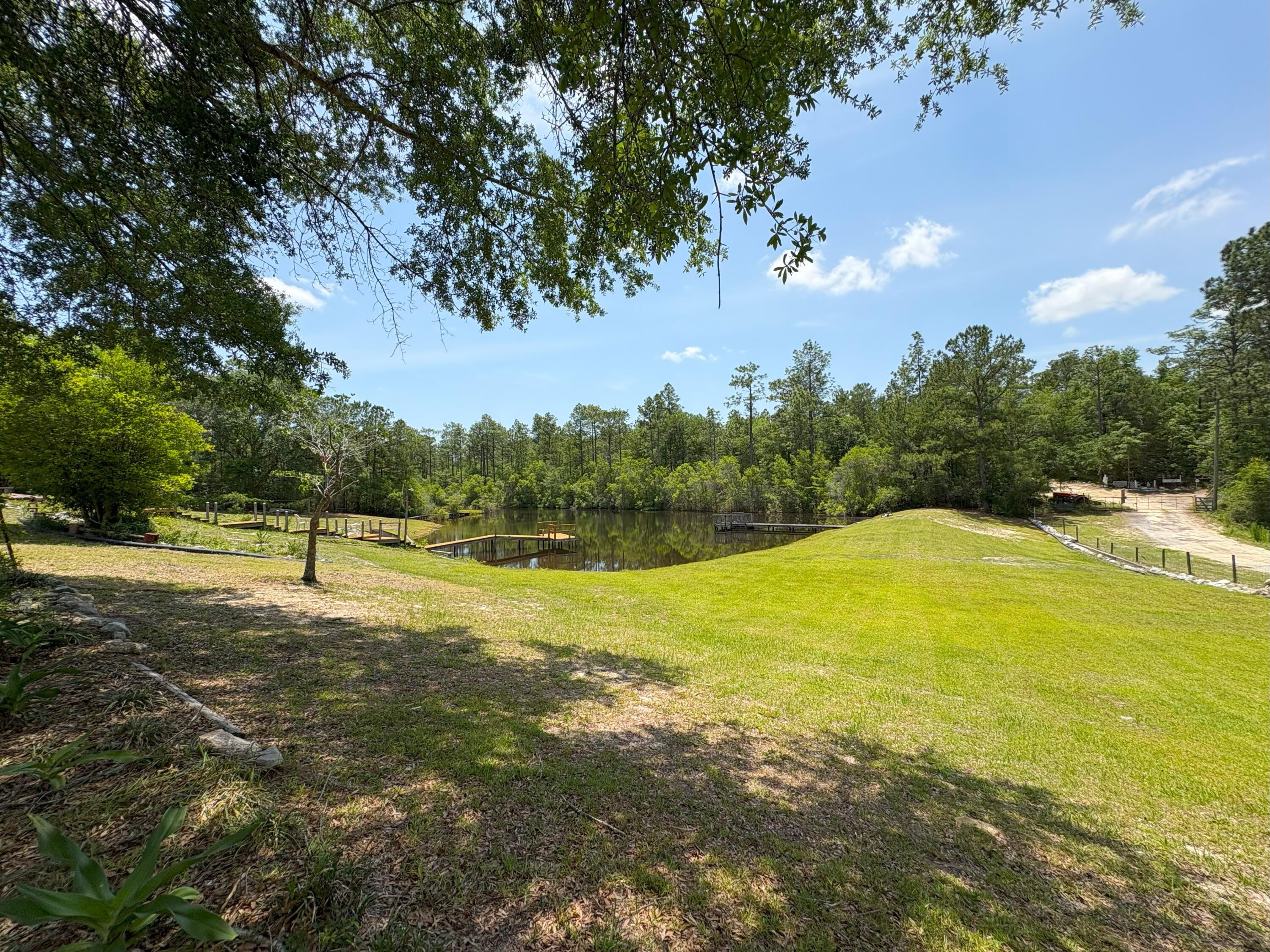 3864 Bear Head Road Crestview, FL 32539 - Photo 33 of 57 a view of a swimming pool with an outdoor space and seating area