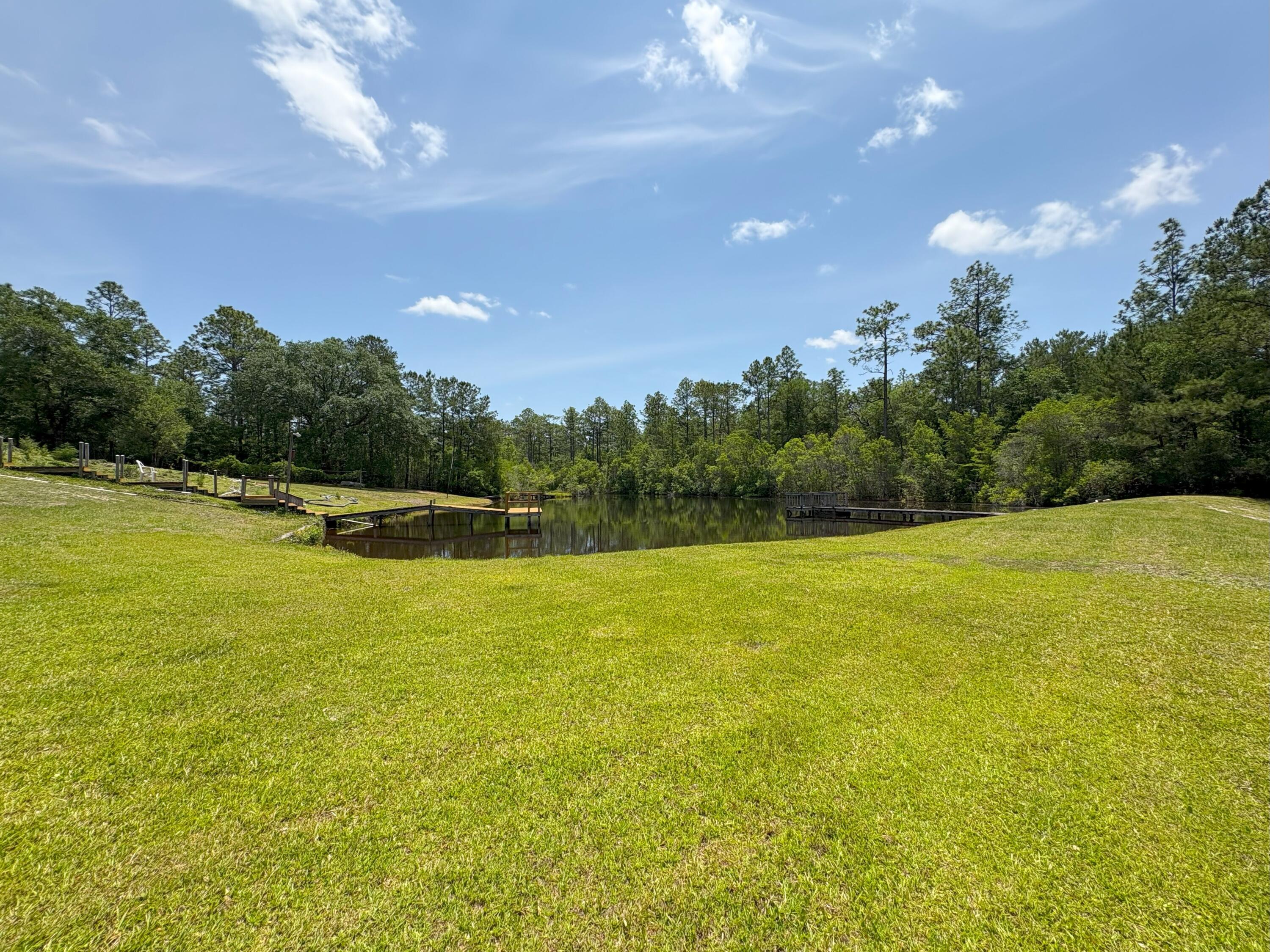 3864 Bear Head Road Crestview, FL 32539 - Photo 35 of 57 a view of a swimming pool with an outdoor space and seating area
