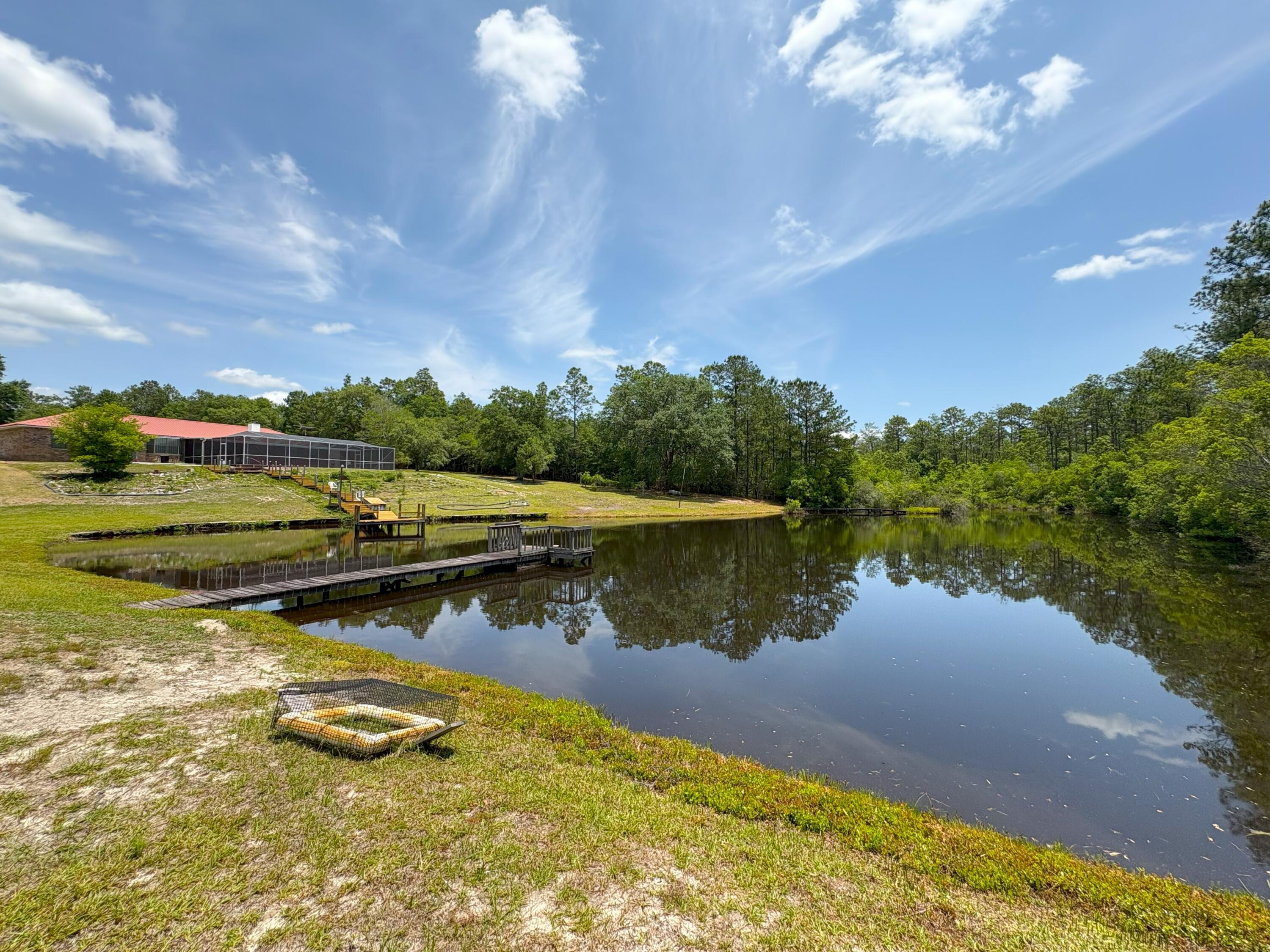 3864 Bear Head Road Crestview, FL 32539 - Photo 36 of 57 a view of a lake in middle of a house with a lake view
