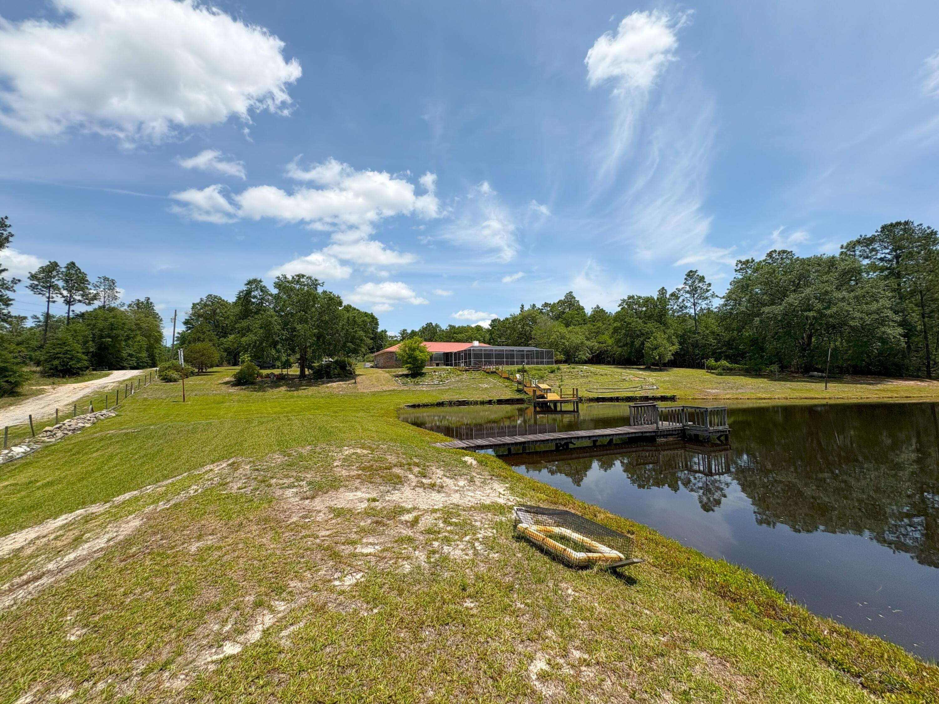 3864 Bear Head Road Crestview, FL 32539 - Photo 37 of 57 a view of a lake with a house in the background