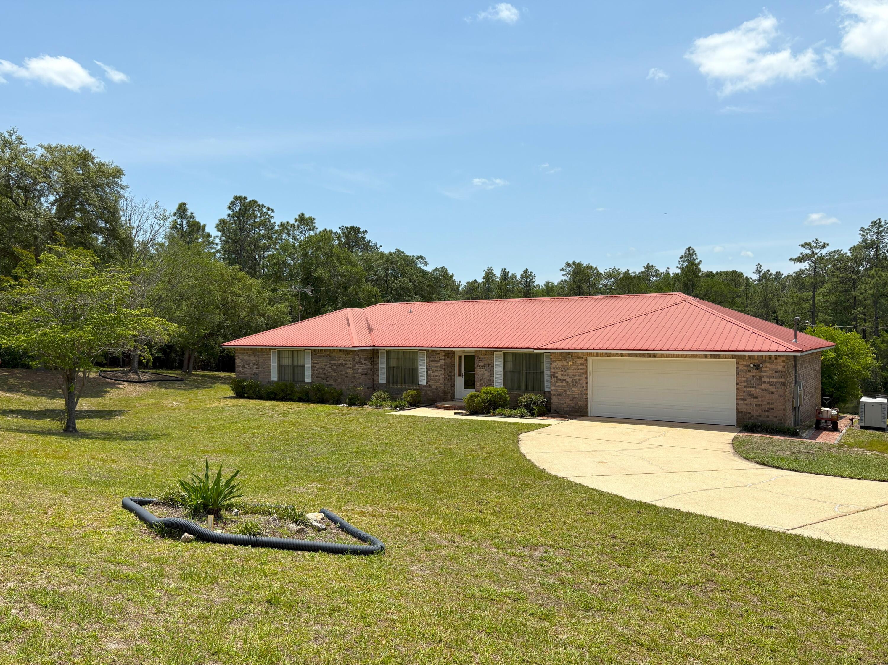 3864 Bear Head Road Crestview, FL 32539 - Photo 4 of 57 a front view of a house with a yard and trees