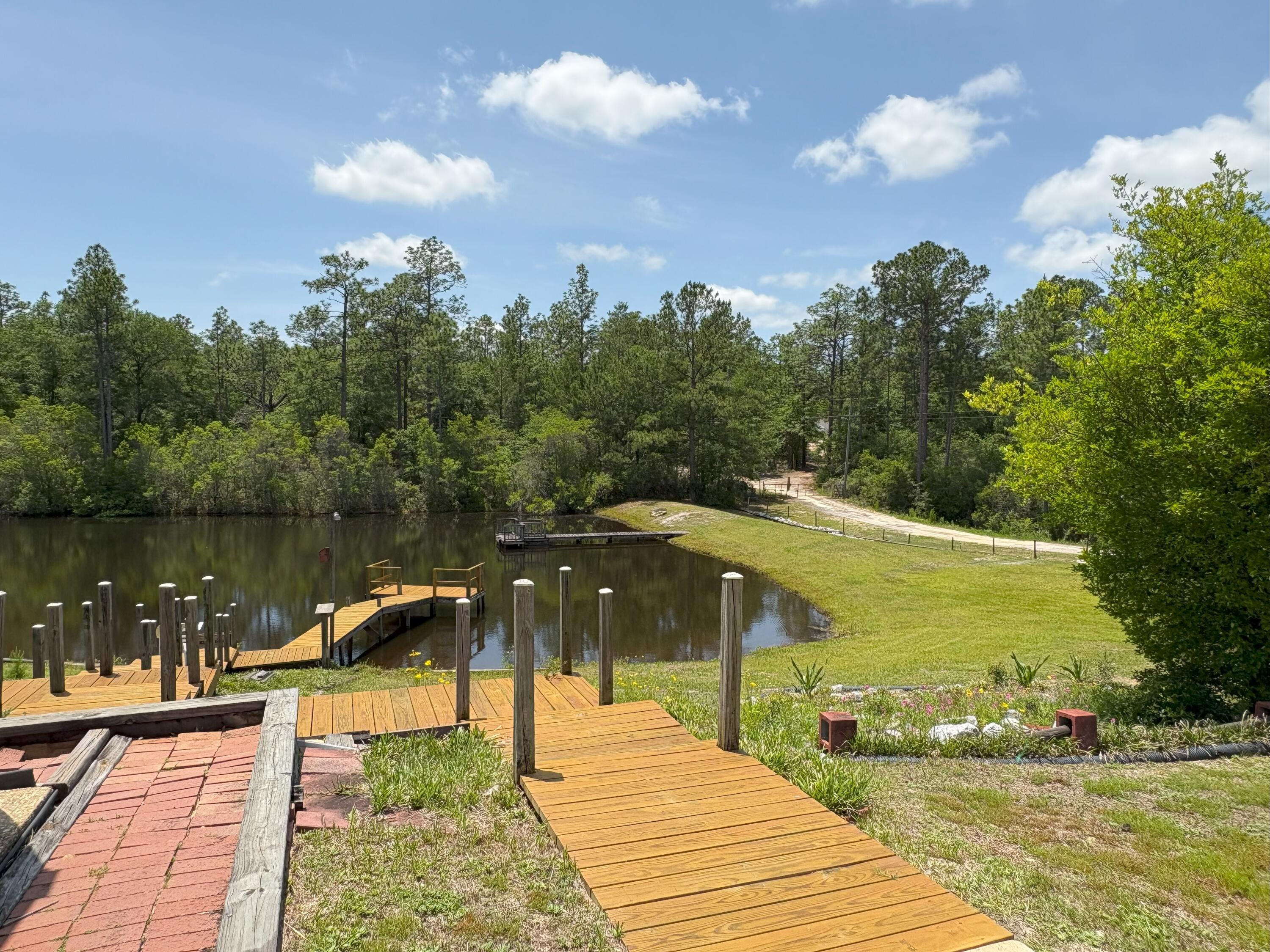 3864 Bear Head Road Crestview, FL 32539 - Photo 42 of 57 a lake view with a garden